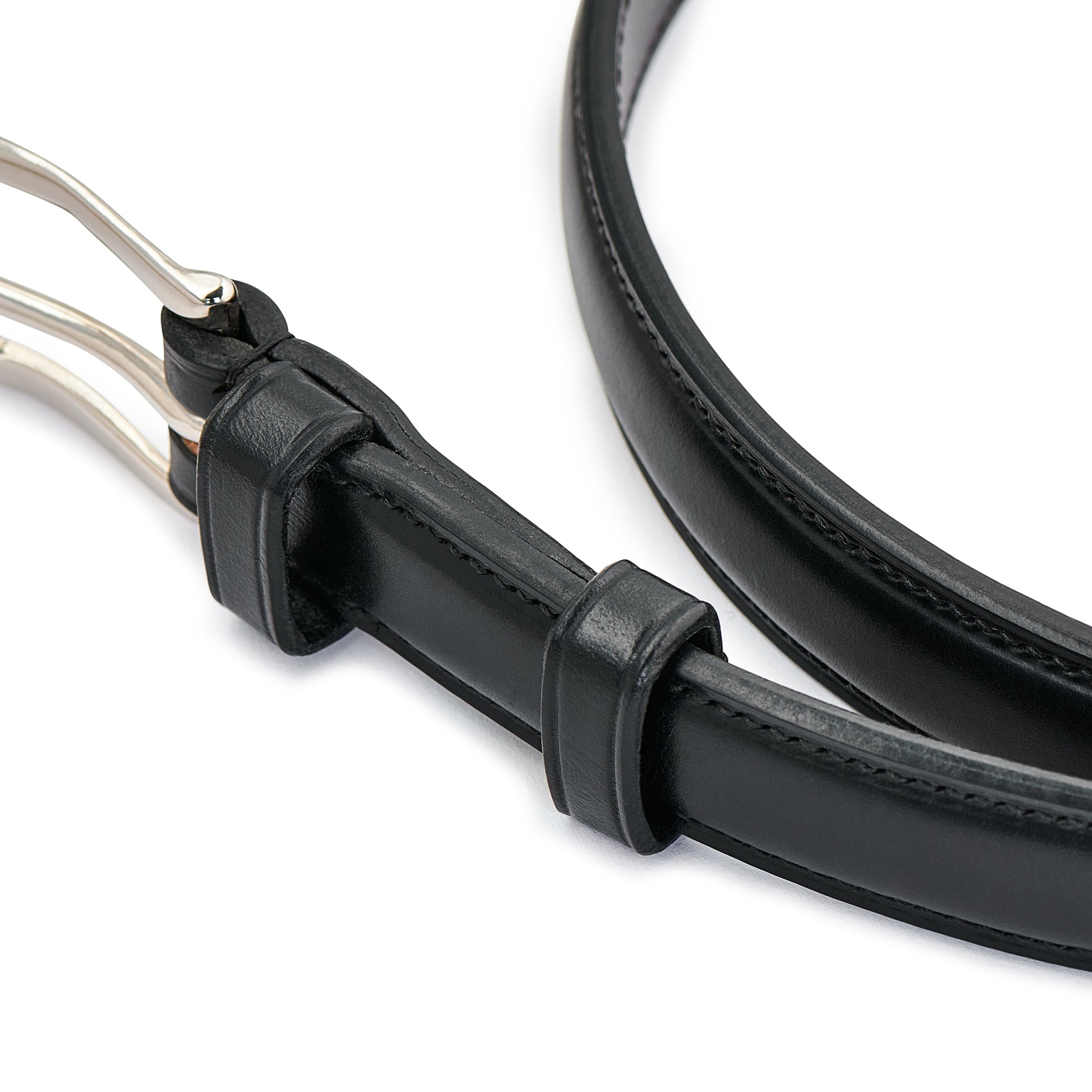 Detail of silver finish buckle and leather keepers on black raised belt