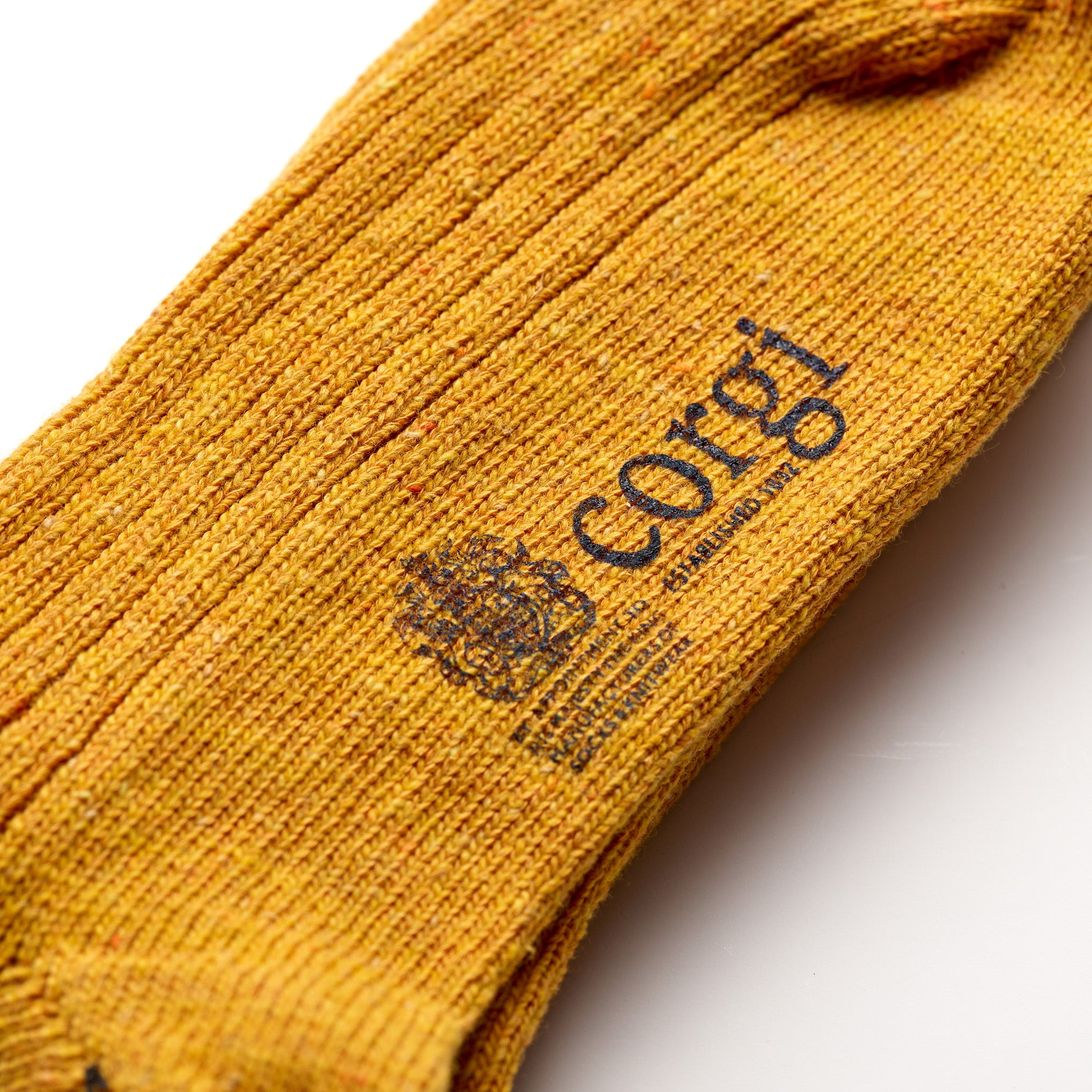 Corgi Heavyweight Plain Donegal Socks in Gold foot logo and knit texture close-up
