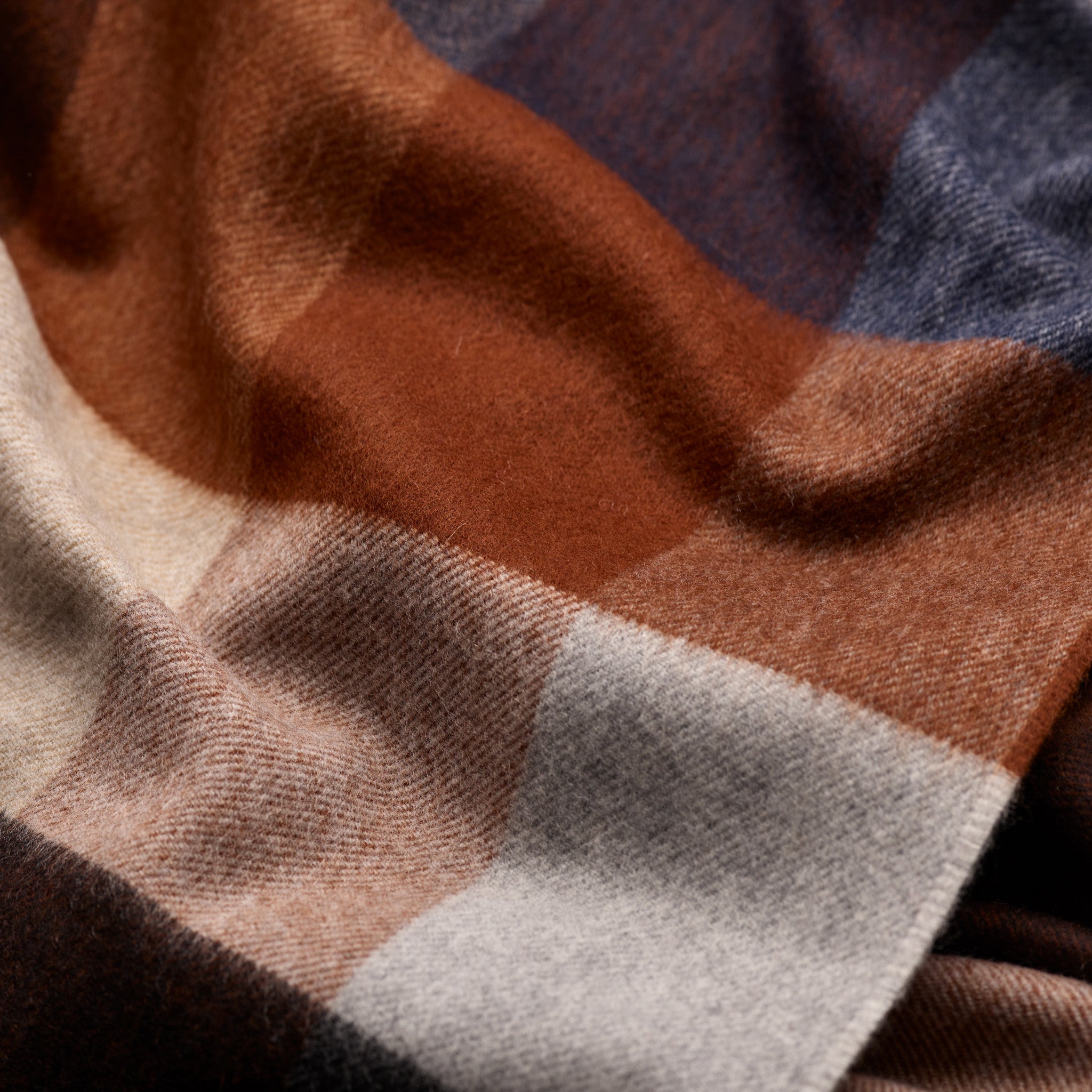 Close-up of brown and navy check pattern on Fox cashmere and wool scarf