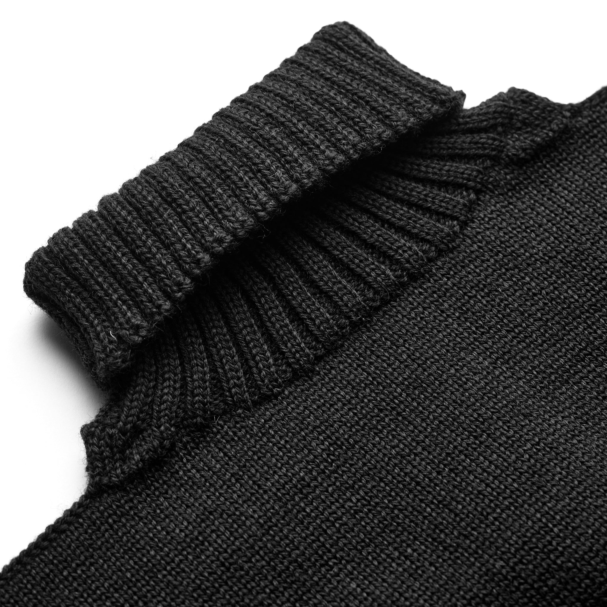 Detail of the roll neck on the Guernsey Woollens x Fox knit in Midnight Black