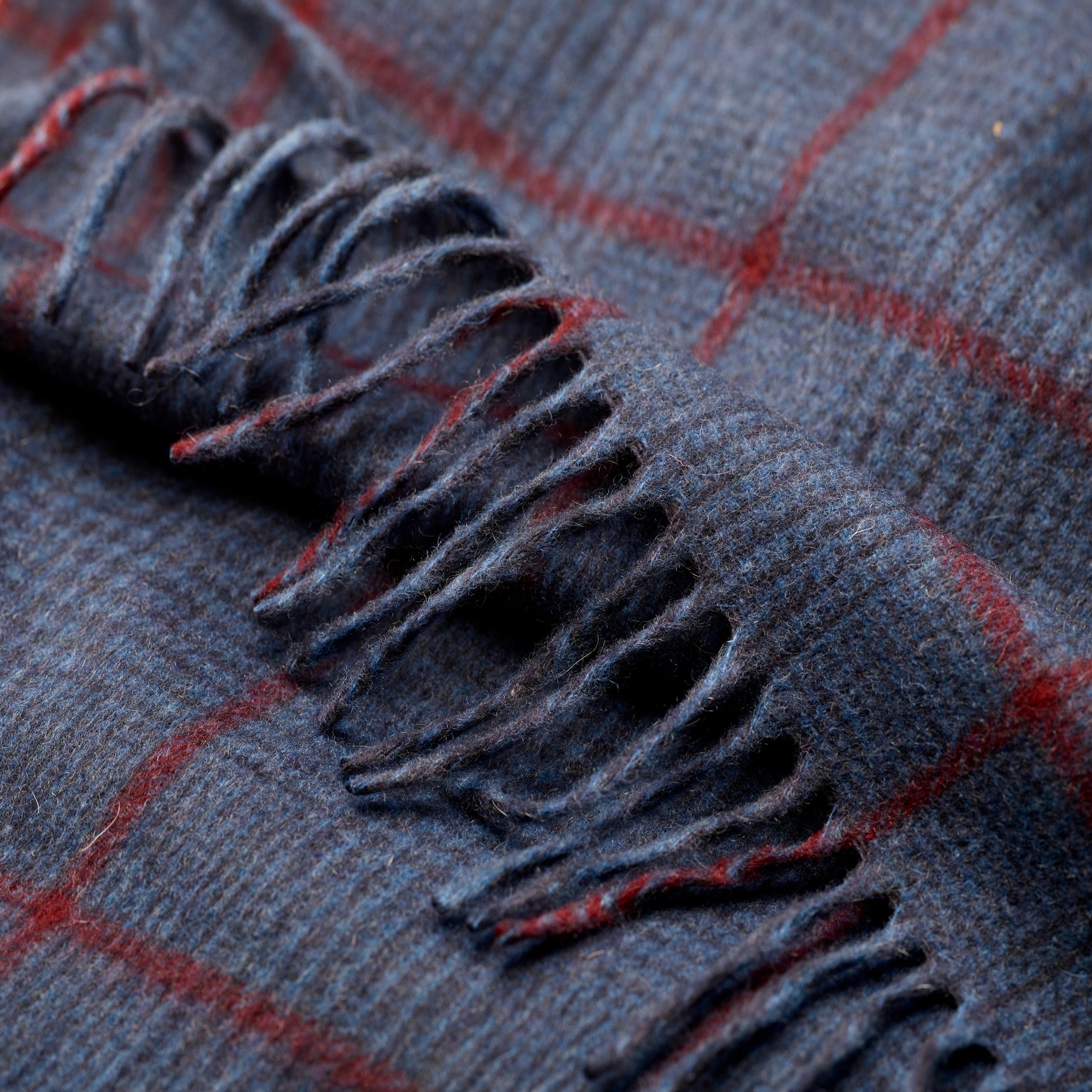 Fringe detail of Fox navy heather and crimson cashmere scarf
