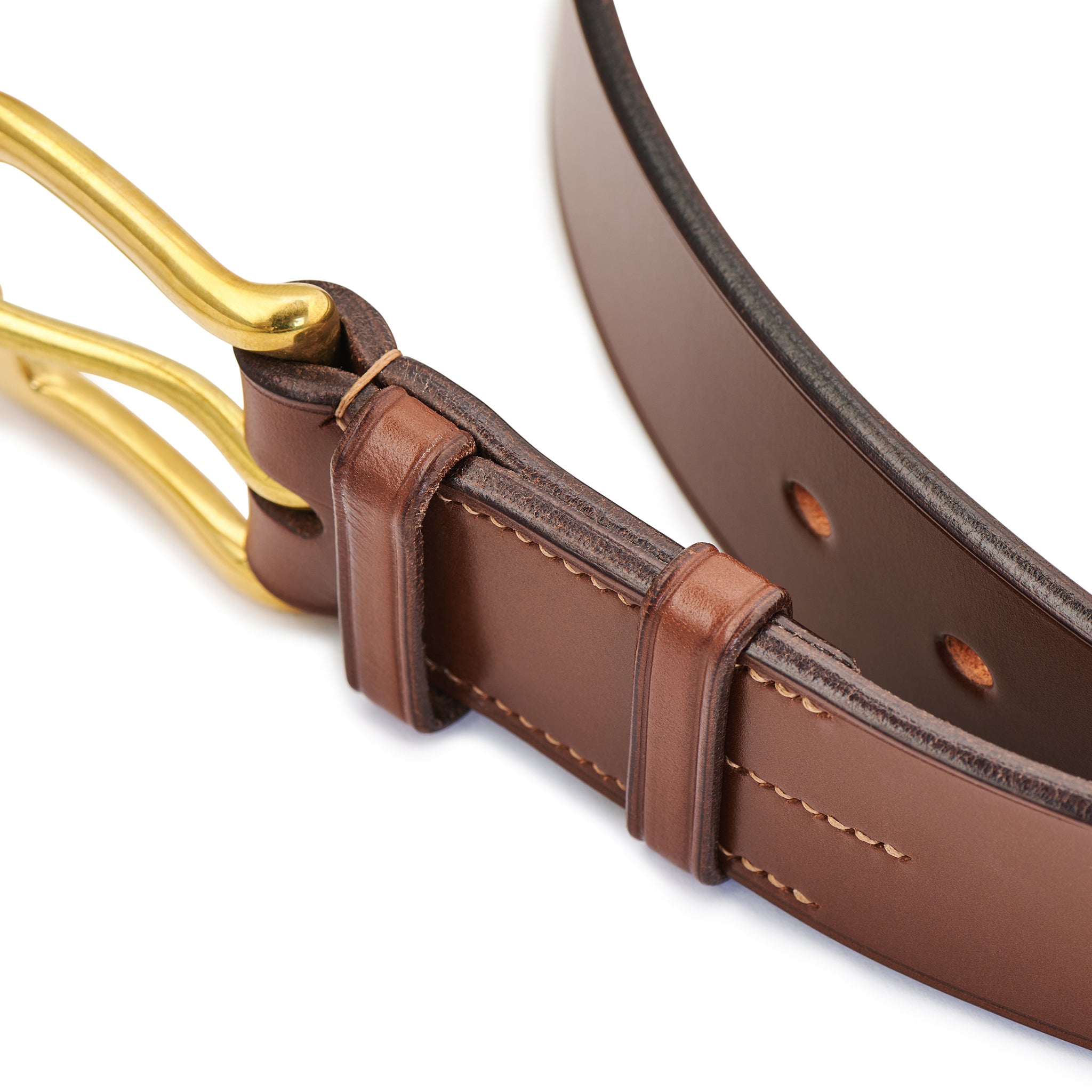 Detail of brass buckle and leather keepers on chestnut bridle leather belt